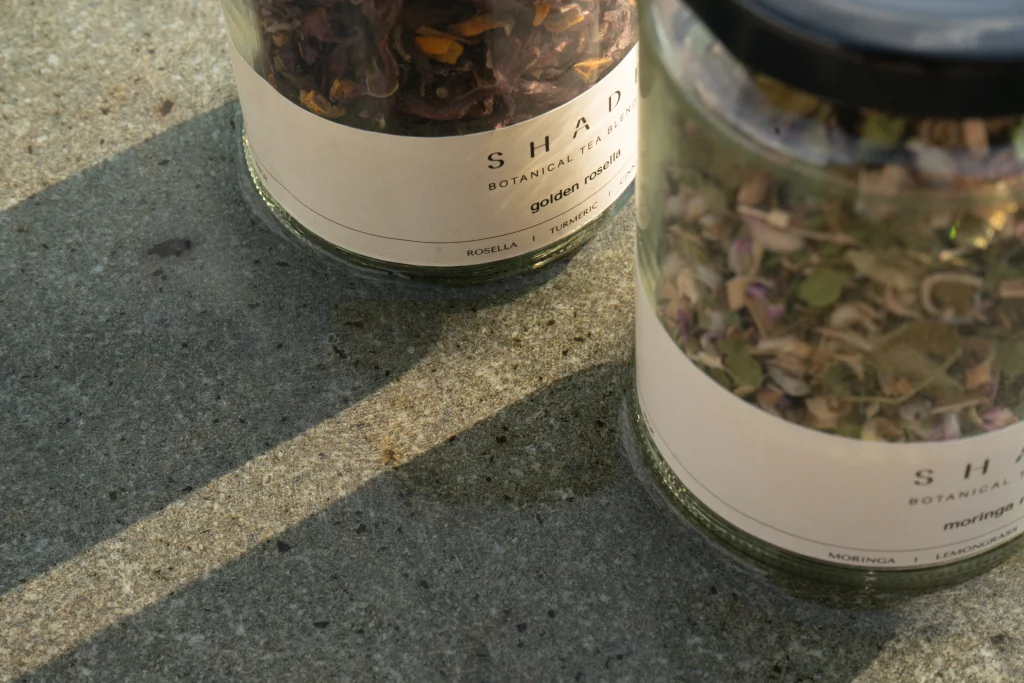 SHADE_Botanicals_-_Loose_Leaf_Tea_Blends_-_Drinking_Lifetyle_-_330_mL_Recycled_Glass_Jar_-_Golden_Rosella_and_Moringa_Melody_Variant