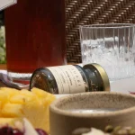 SHADE_Botanicals_-_Loose_Leaf_Tea_Blends_-_Drinking_Lifetyle_-_70_mL_Recycled_Glass_Jar_and_Iced_Tea_Bottle_-_Golden_Rosella_and_Moringa_Melody_Variant